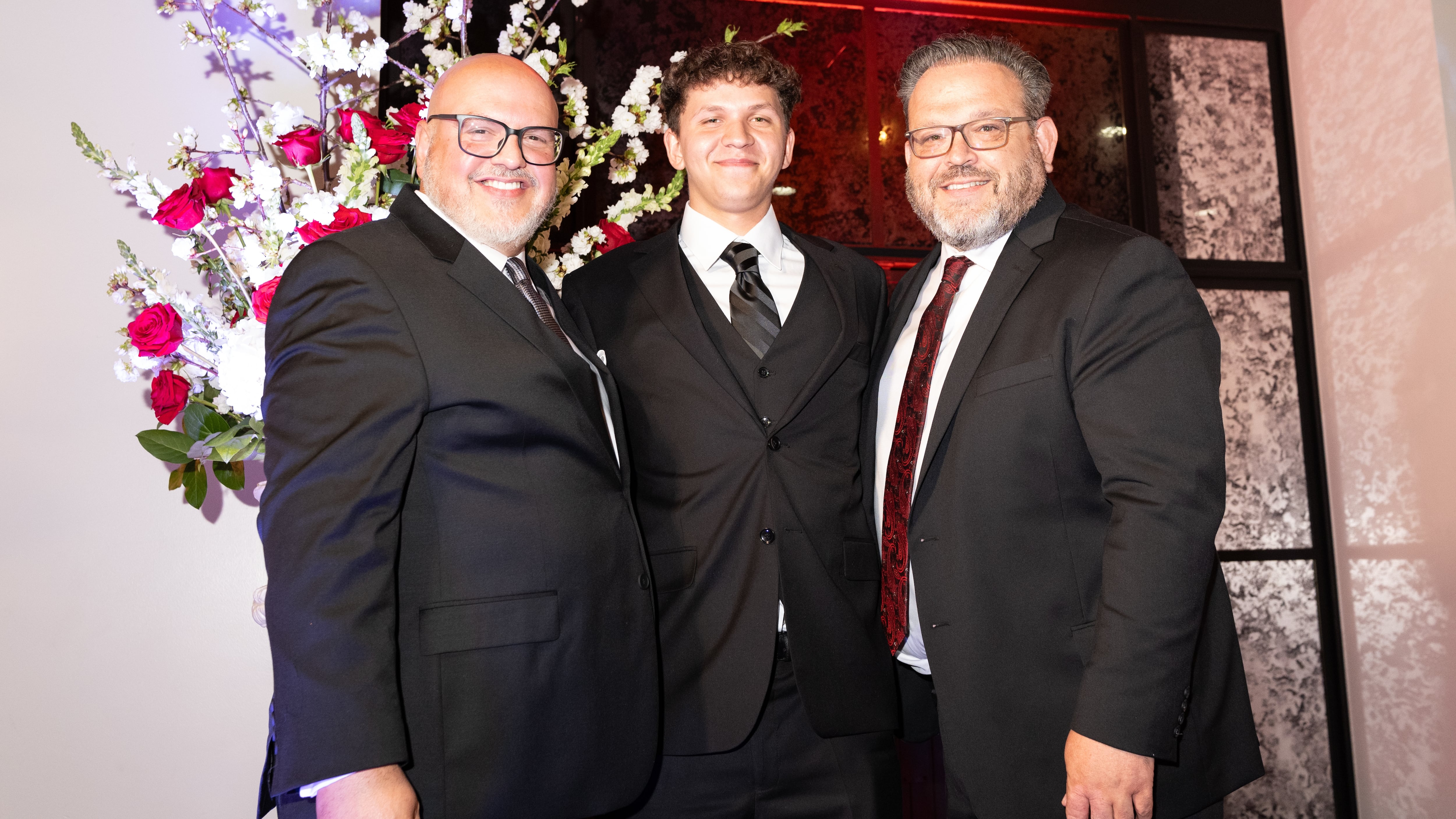 Petra Cares graduate Eli Staats, center, is flanked by Petra Automotive Products CEO Arnold Gacita Sr., left, and Petra Cares Executive Director Brian Meza.